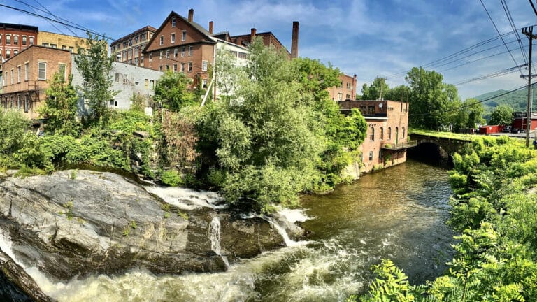 flowing whetstone brook with historic downtown brattleboro, vermont